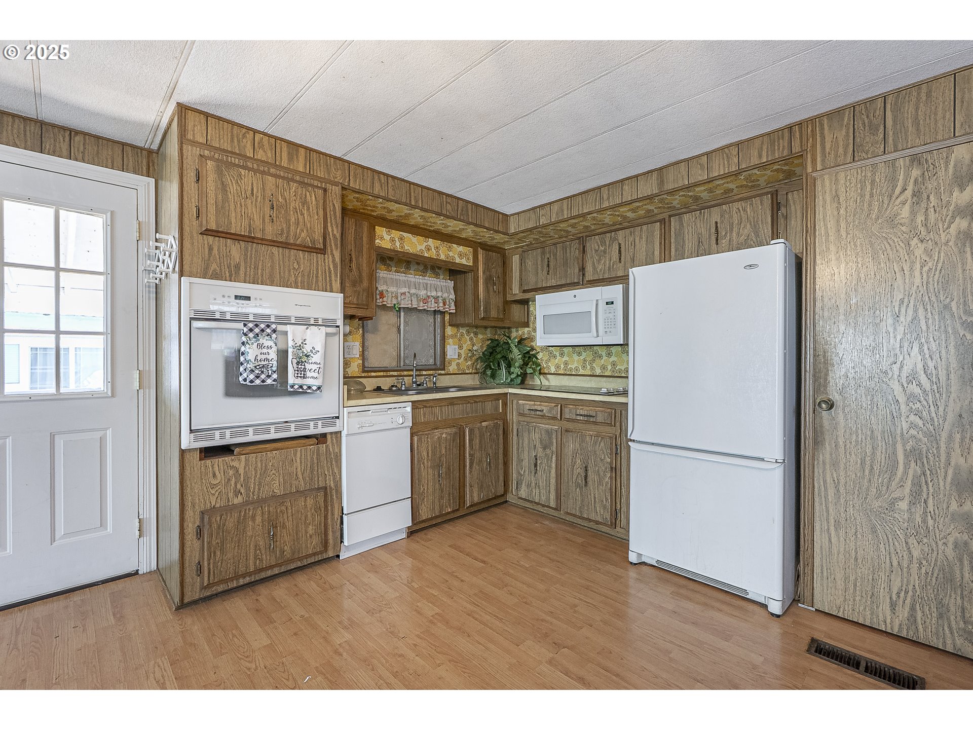 2150 Laura Street, Unit 57 Springfield, OR 97477 - Photo 21 of 23 a kitchen with white cabinets and white appliances