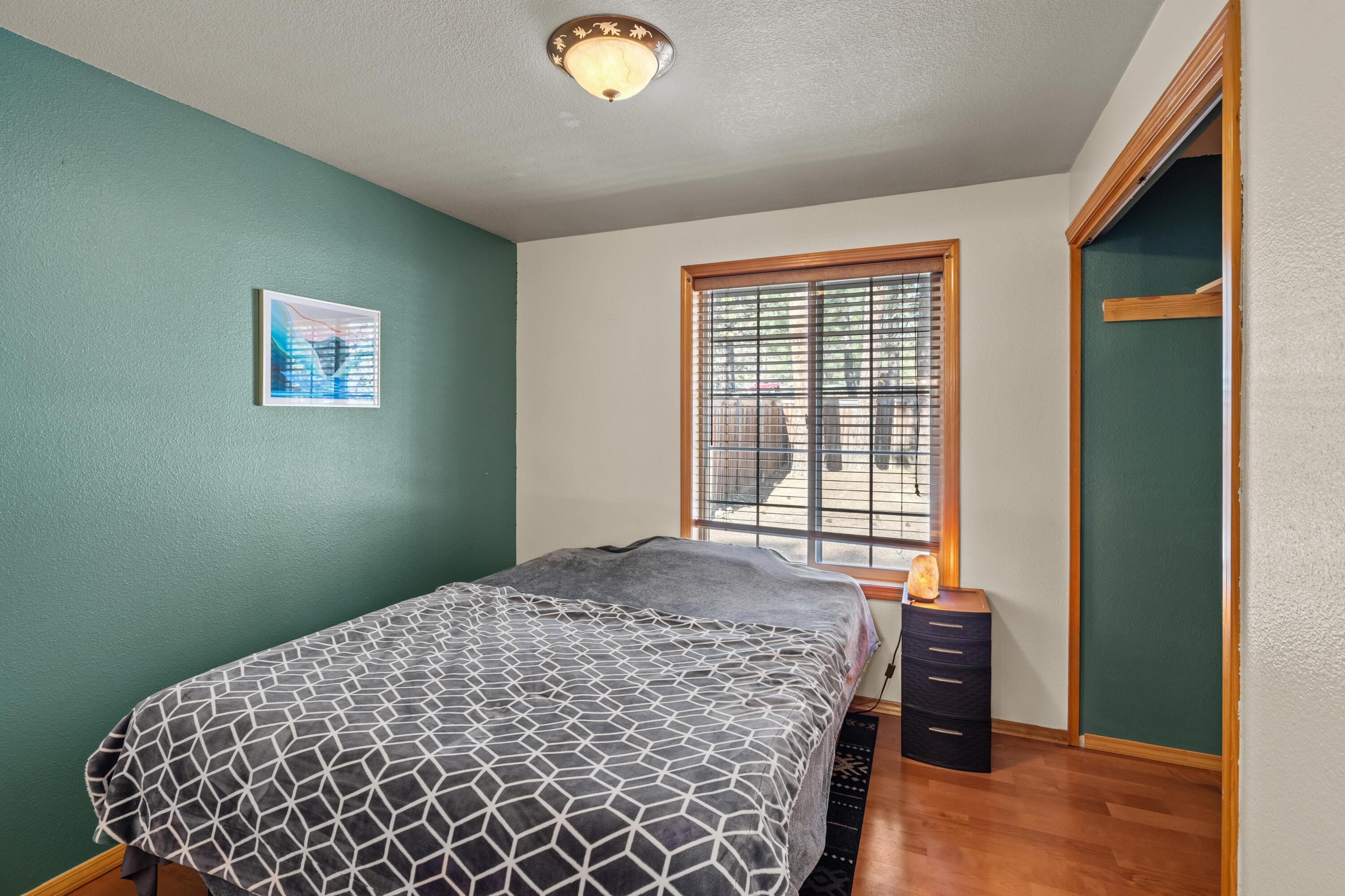 19102 Choctaw Road Bend, OR 97702 - Photo 8 of 14 a bedroom with a bed and a window