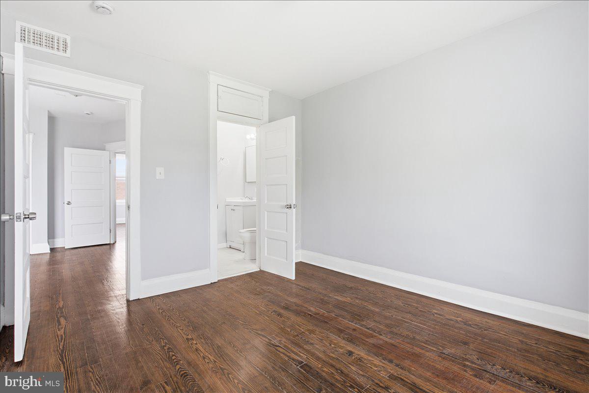1231 North Potomac Street Baltimore, MD 21213 - Photo 17 of 25 a view of empty room with wooden floor