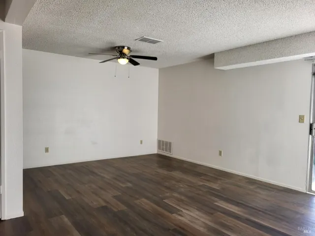 a view of a room with wooden floor