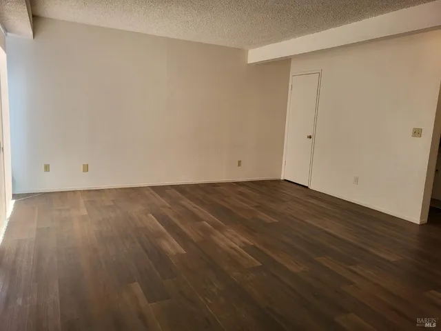 a view of room with wooden floor