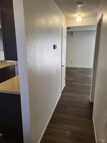 a view of hallway with wooden floor