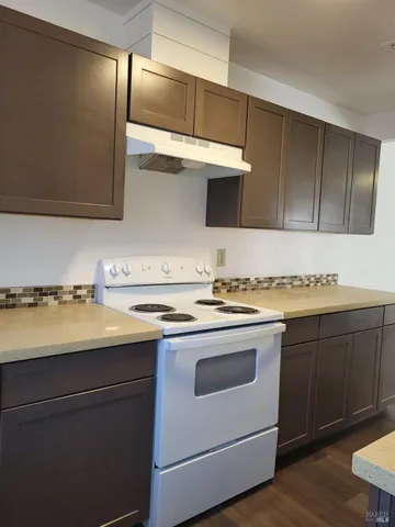 a kitchen with stainless steel appliances granite countertop a sink and a stove