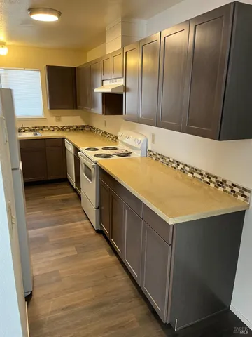 a kitchen with stainless steel appliances a sink and a refrigerator
