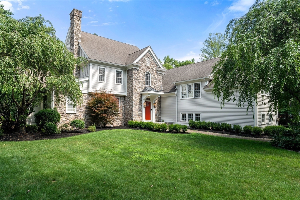 a front view of house with yard and green space