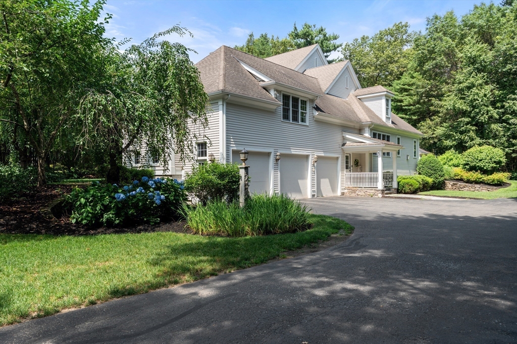 114 Fox Run Road Bolton, MA 01740 - Photo 2 of 37 a front view of a house with a garden