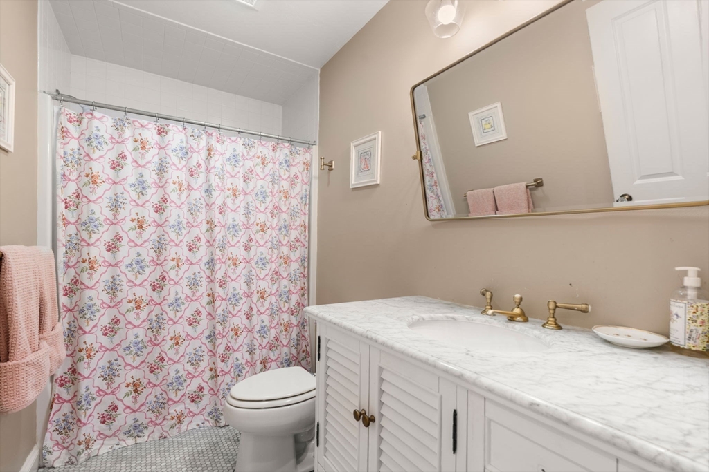 114 Fox Run Road Bolton, MA 01740 - Photo 22 of 37 a bathroom with a granite countertop sink a toilet and a mirror
