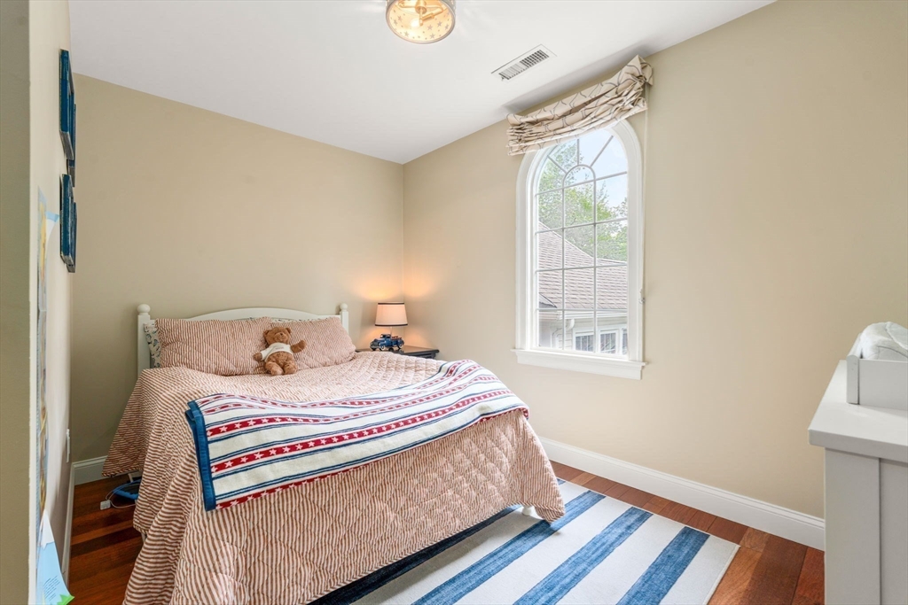 114 Fox Run Road Bolton, MA 01740 - Photo 26 of 37 a bedroom with a bed and wooden floor