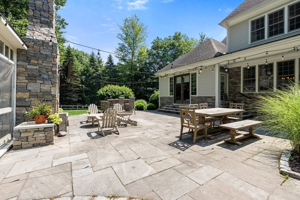 114 Fox Run Road Bolton, MA 01740 - Photo 31 of 37 a view of backyard with outdoor seating a patio and plants
