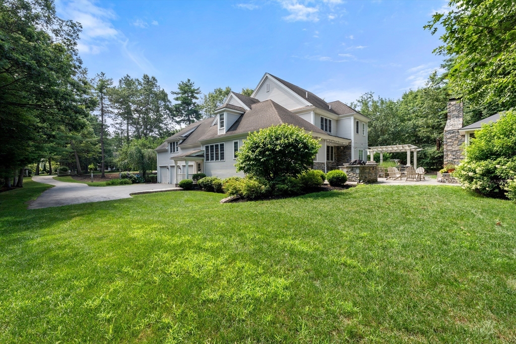 114 Fox Run Road Bolton, MA 01740 - Photo 36 of 37 a front view of a house with a yard table and chairs