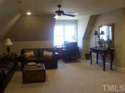 1021 Quiet Ridge Circle Raleigh, NC 27614 - Photo 6 of 9 a living room with furniture and a chandelier
