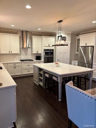 2500 Walnut View Drive Howell, MI 48855 - Photo 14 of 41 Kitchen with a center island, dark wood-style floors, white cabinetry, a breakfast bar, and recessed lighting