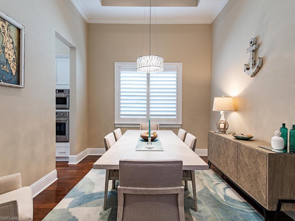 6445 Pembroke Way Naples, FL 34113 - Photo 11 of 40 a dining room with furniture and window