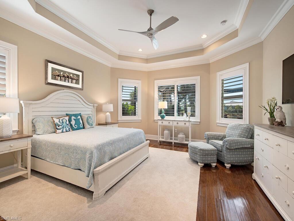 6445 Pembroke Way Naples, FL 34113 - Photo 13 of 40 a spacious bedroom with a bed and a couch