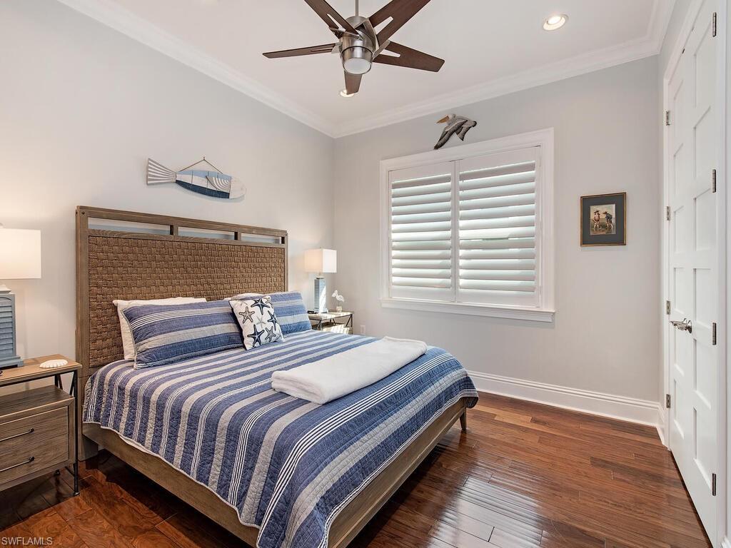6445 Pembroke Way Naples, FL 34113 - Photo 15 of 40 a bedroom with a bed and window