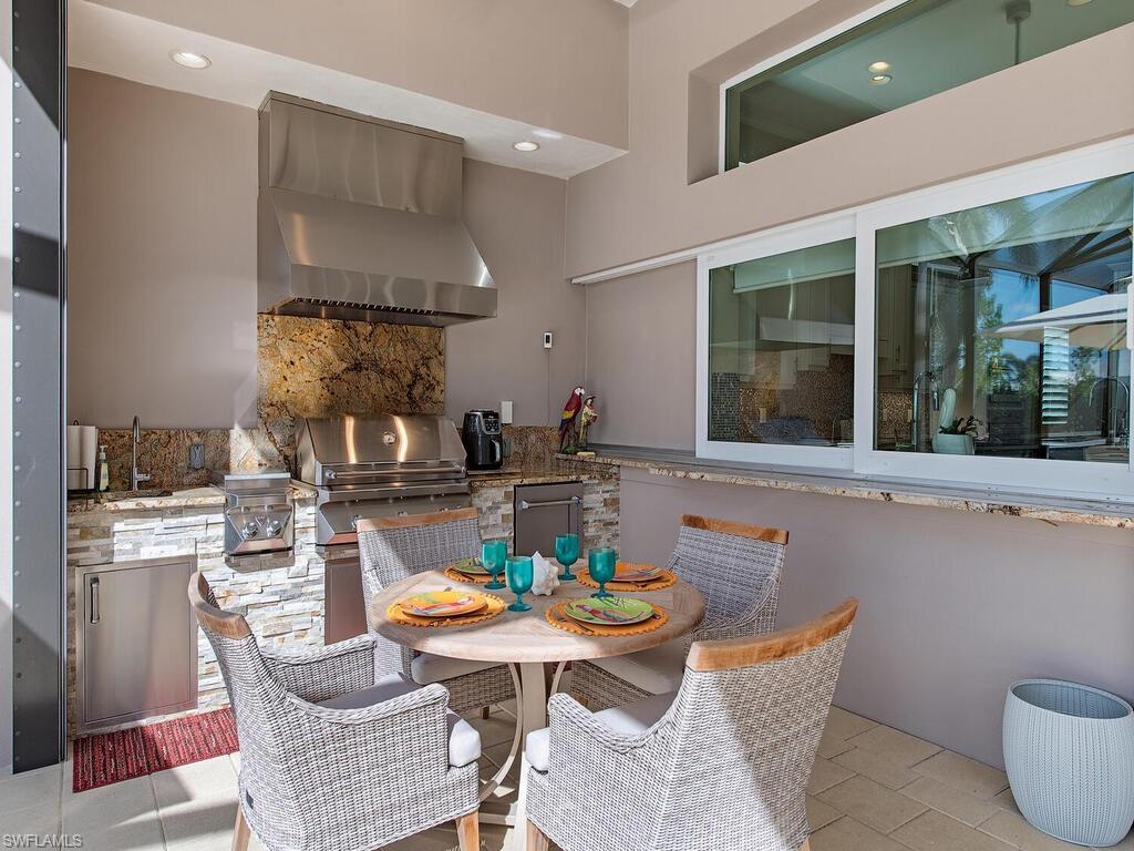 6445 Pembroke Way Naples, FL 34113 - Photo 21 of 40 a dining room with a table and chairs