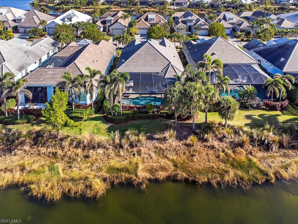 6445 Pembroke Way Naples, FL 34113 - Photo 23 of 40 a view of a house with a yard and a large pool