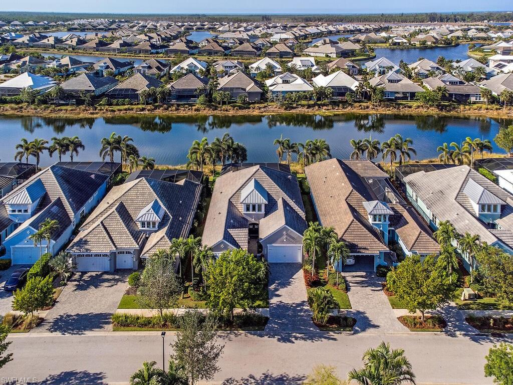 6445 Pembroke Way Naples, FL 34113 - Photo 3 of 40 an aerial view of a house with a lake view