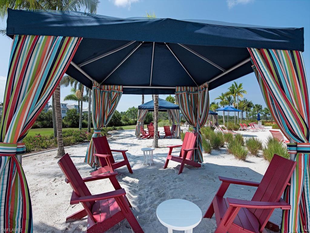 6445 Pembroke Way Naples, FL 34113 - Photo 34 of 40 a view of deck with chairs and table under an umbrella