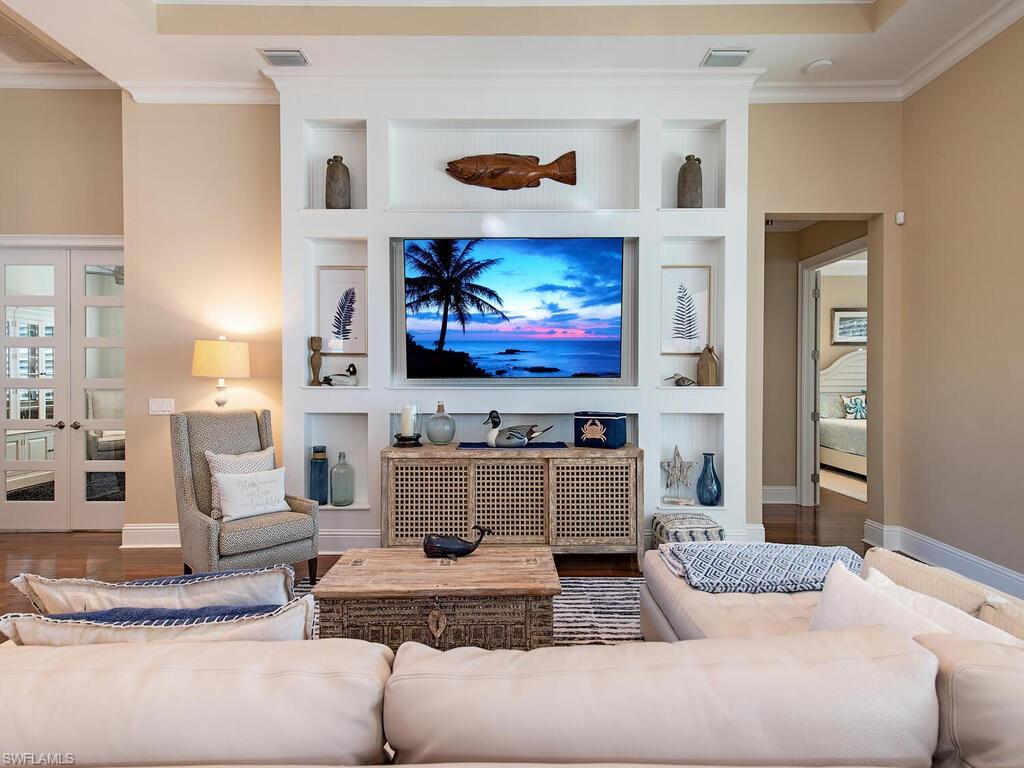 6445 Pembroke Way Naples, FL 34113 - Photo 6 of 40 a living room with furniture and a flat screen tv