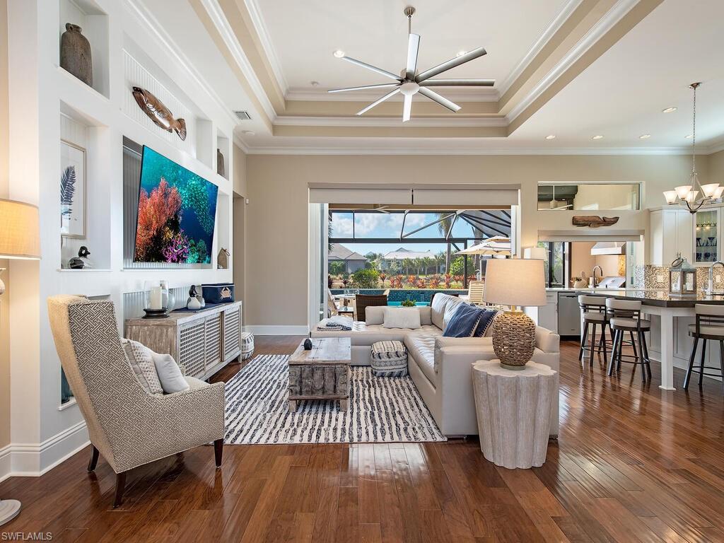 6445 Pembroke Way Naples, FL 34113 - Photo 7 of 40 a living room with furniture and a large window