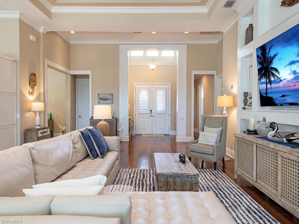 6445 Pembroke Way Naples, FL 34113 - Photo 8 of 40 a living room with furniture and a flat screen tv