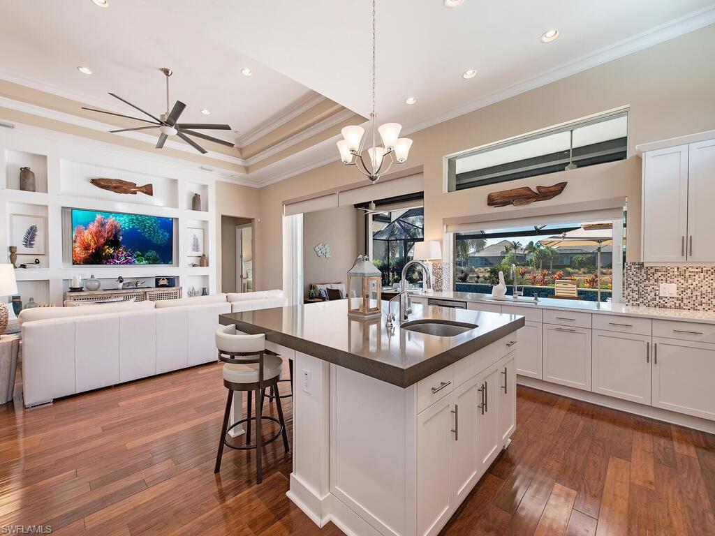 6445 Pembroke Way Naples, FL 34113 - Photo 10 of 40 a kitchen with white cabinets and sink