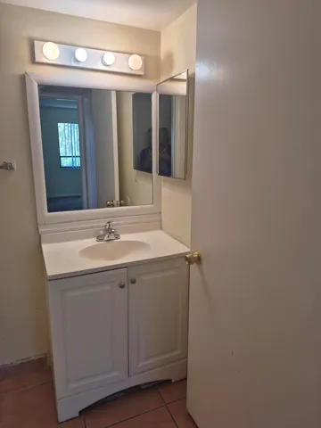 a bathroom with a sink and mirror