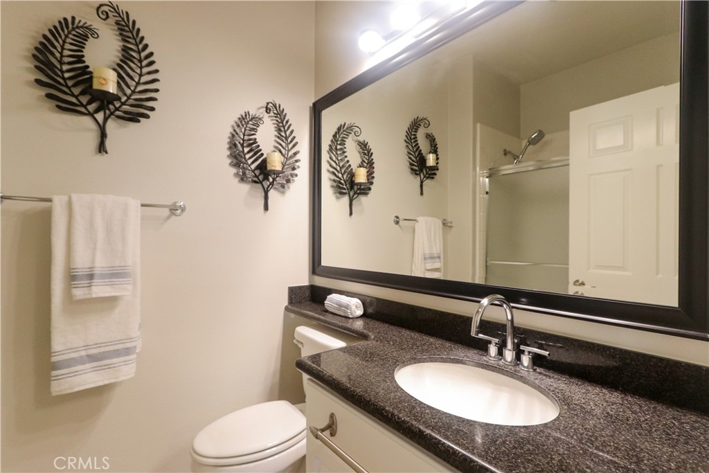 327 Tomko Way Placentia, CA 92870 - Photo 22 of 47 a bathroom with a granite countertop sink toilet and mirror