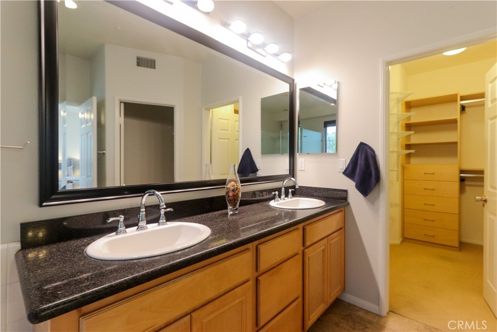 327 Tomko Way Placentia, CA 92870 - Photo 29 of 47 a bathroom with a granite countertop sink and a mirror