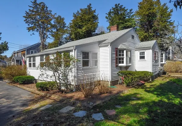 a backyard of a house with plants and outdoor seating