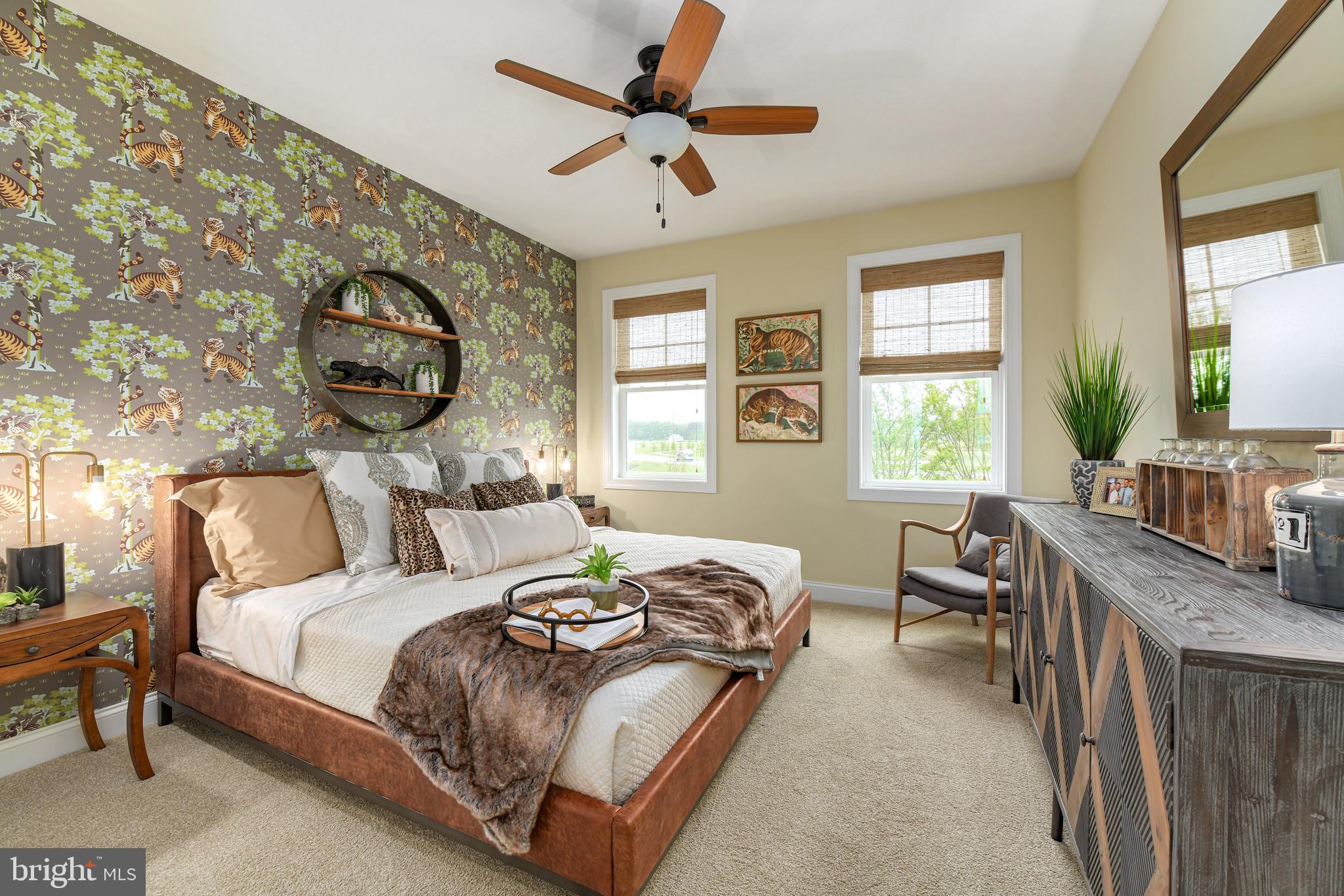 21810 Eastbridge Loop Lewes, DE 19958 - Photo 23 of 32 a bedroom with a bed a chandelier and a window