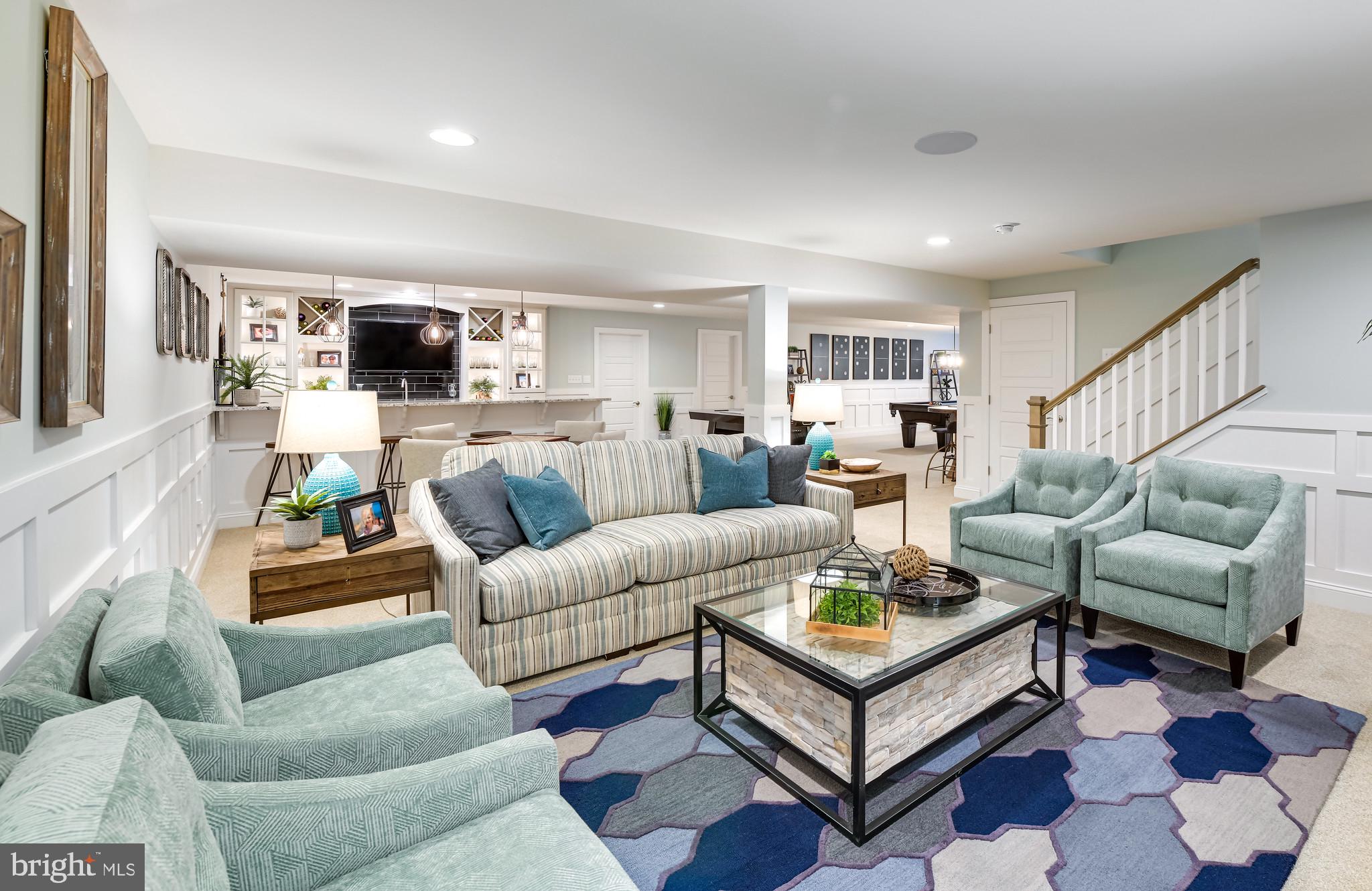 21810 Eastbridge Loop Lewes, DE 19958 - Photo 26 of 32 a living room with furniture a flat screen tv and a window