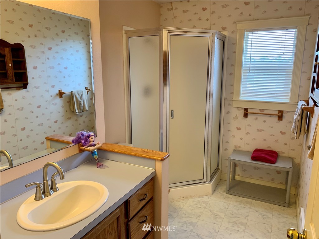 52 Greywolf Road Sequim, WA 98382 - Photo 25 of 31 a bathroom with a sink and a mirror