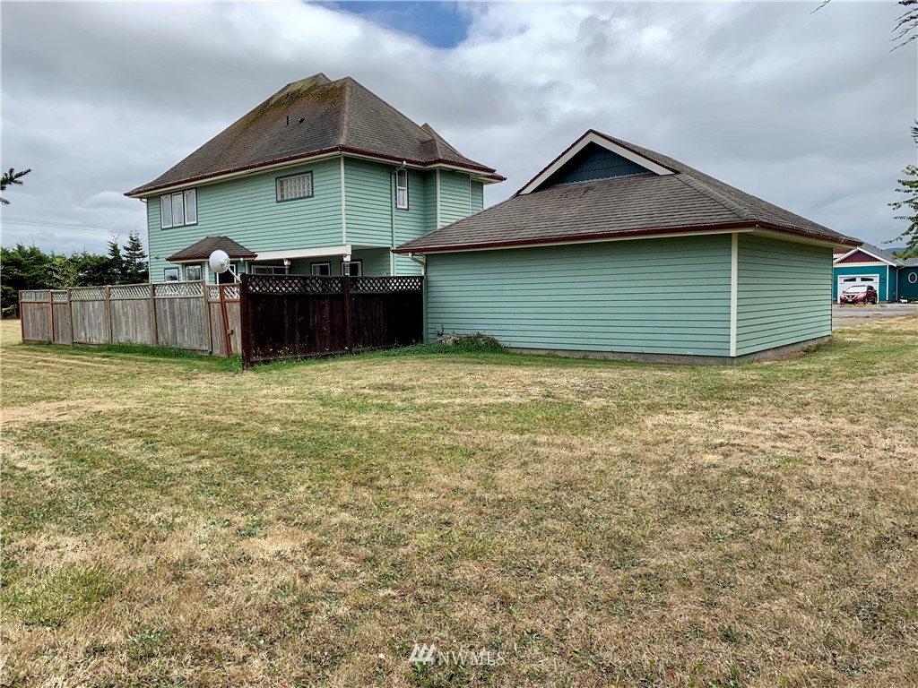 52 Greywolf Road Sequim, WA 98382 - Photo 27 of 31 a view of a house with a yard and garage