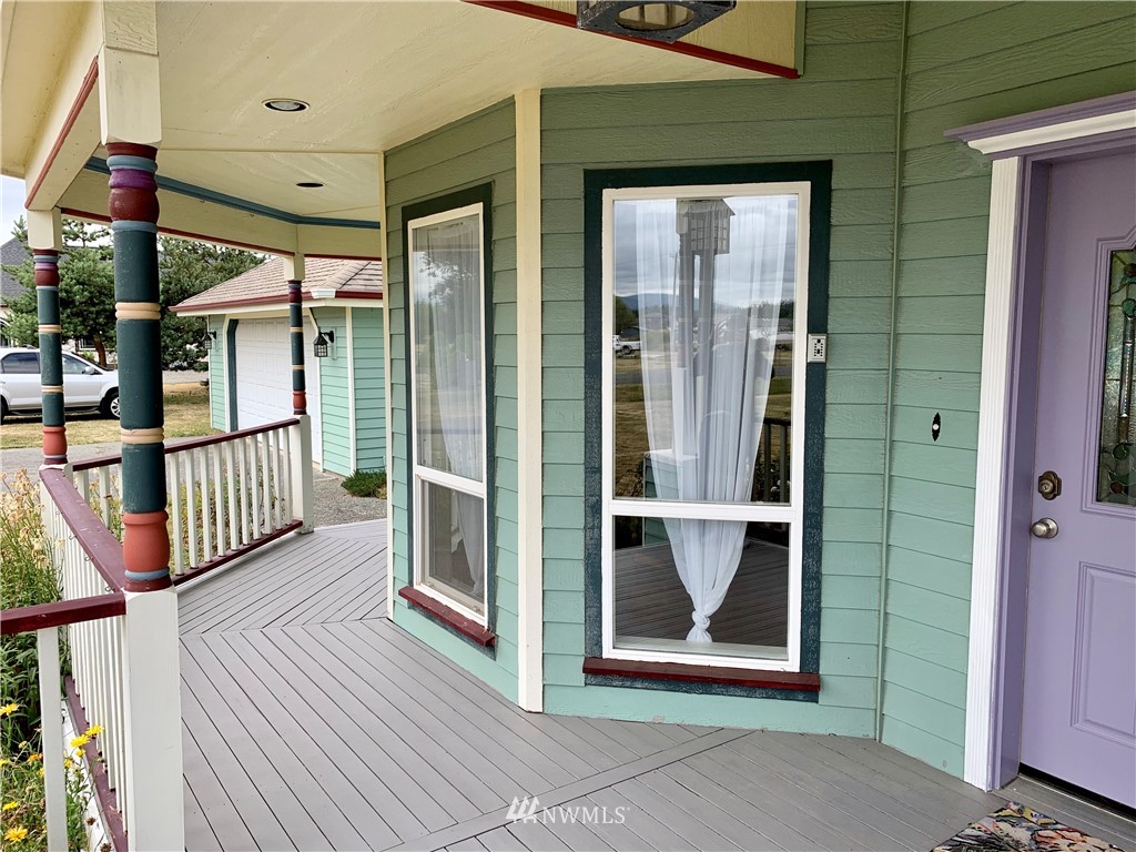 52 Greywolf Road Sequim, WA 98382 - Photo 4 of 31 a view of a porch with wooden floor and windows