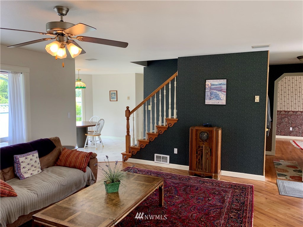 52 Greywolf Road Sequim, WA 98382 - Photo 7 of 31 a living room with furniture and a chandelier