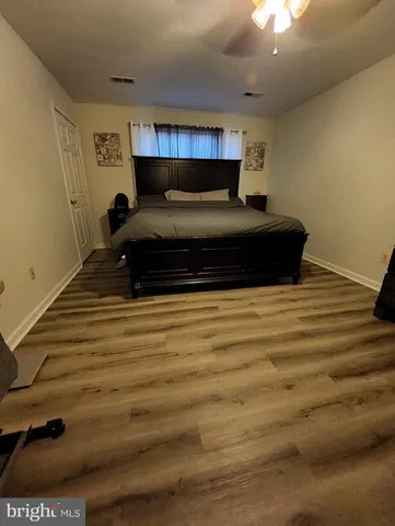 a bathroom with a toilet a sink a mirror and shower curtain