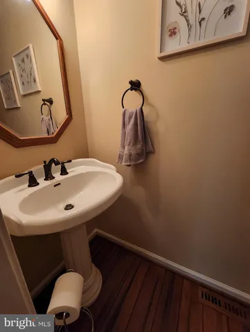 a bathroom with a toilet and a picture on the wall