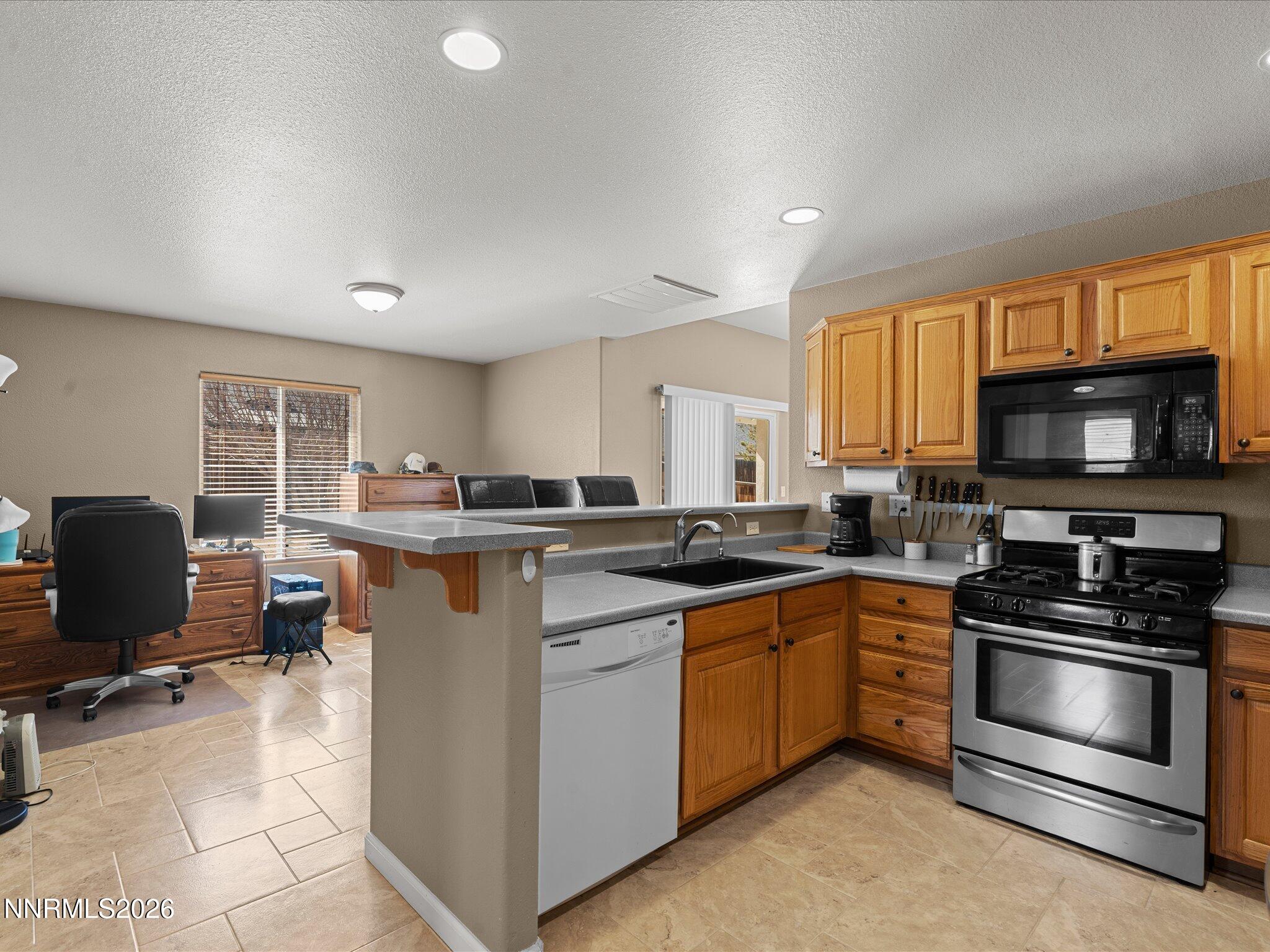 400 Bens Way Fernley, NV 89408 - Photo 11 of 31 a kitchen with counter top space appliances and a window