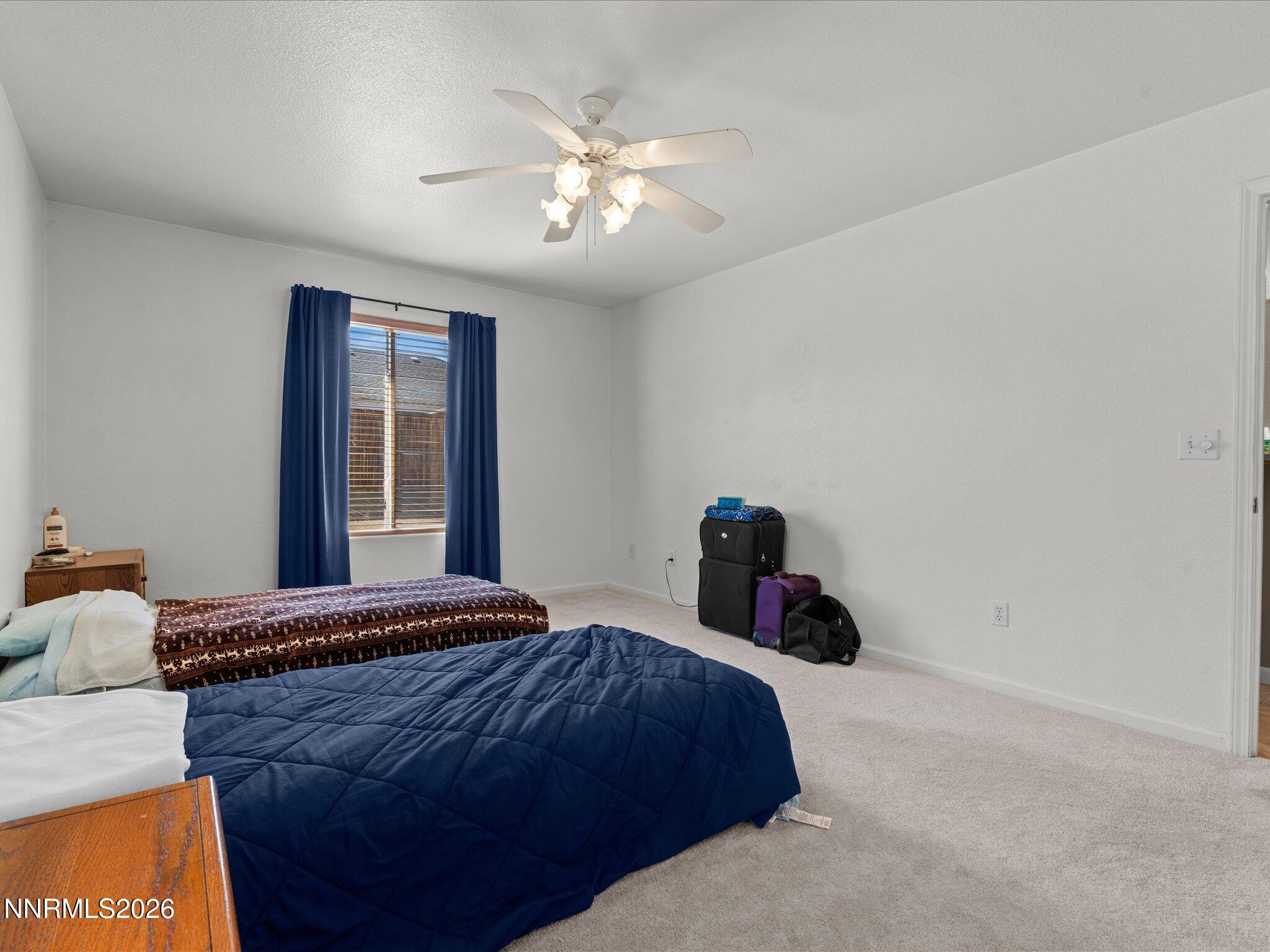 400 Bens Way Fernley, NV 89408 - Photo 17 of 31 a bedroom with a bed and a chandelier