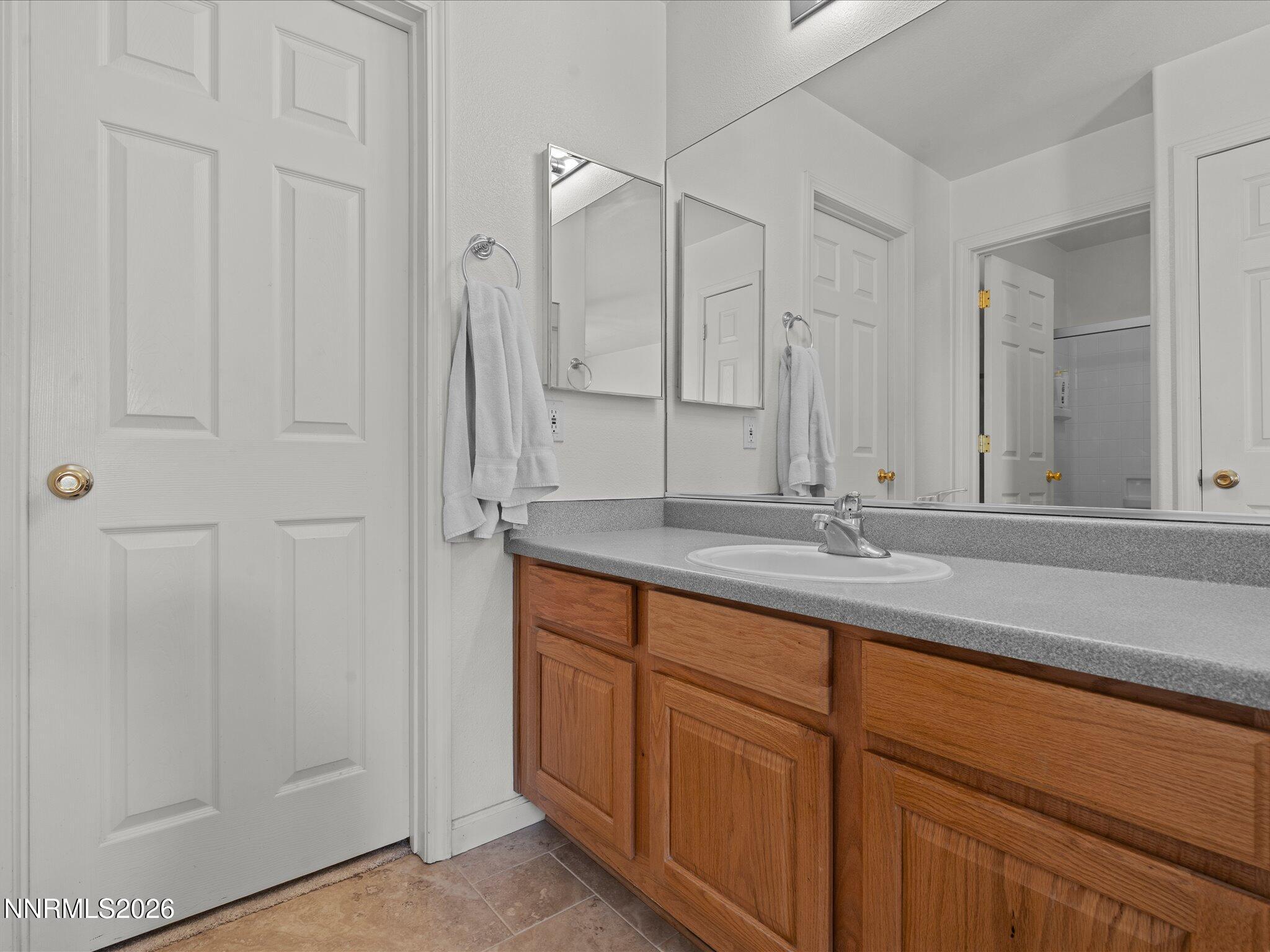400 Bens Way Fernley, NV 89408 - Photo 18 of 31 a bathroom with a granite countertop sink and a mirror