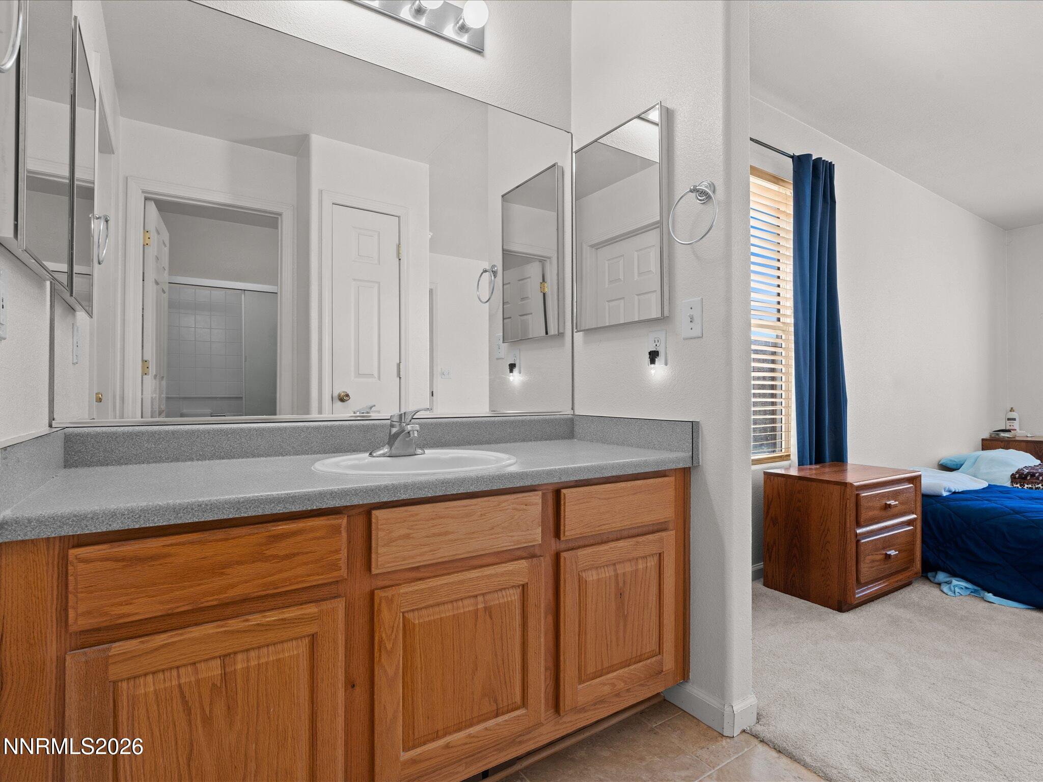 400 Bens Way Fernley, NV 89408 - Photo 20 of 31 a bathroom with a granite countertop sink and a mirror