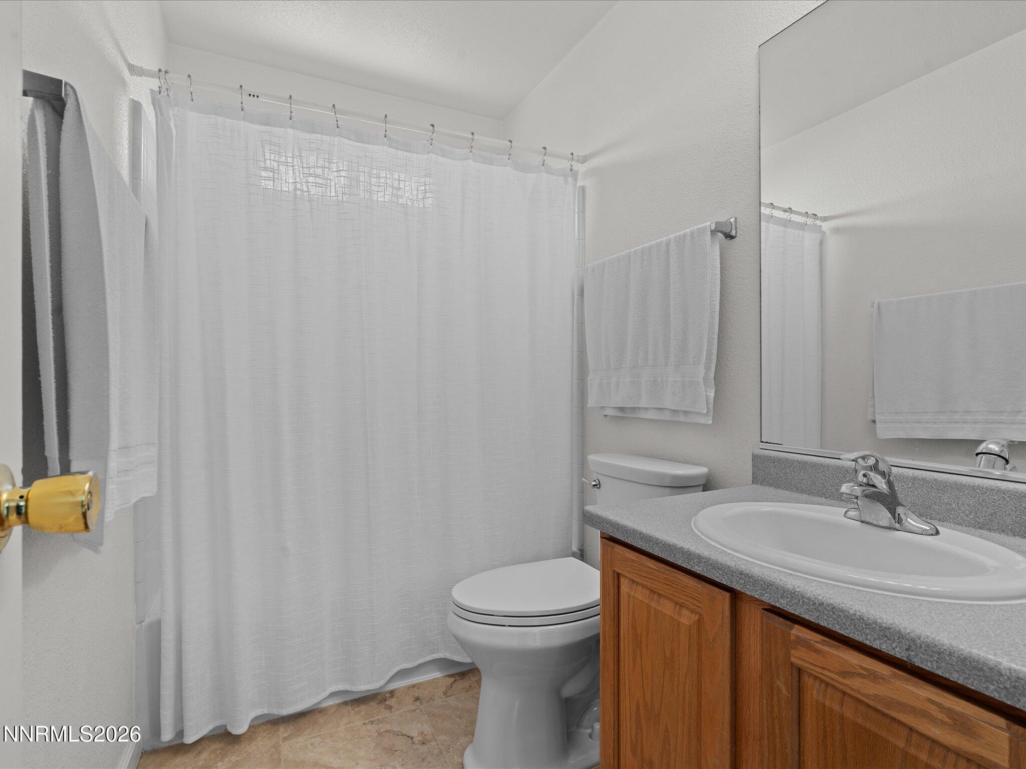 400 Bens Way Fernley, NV 89408 - Photo 25 of 31 a bathroom with a granite countertop sink toilet and a mirror