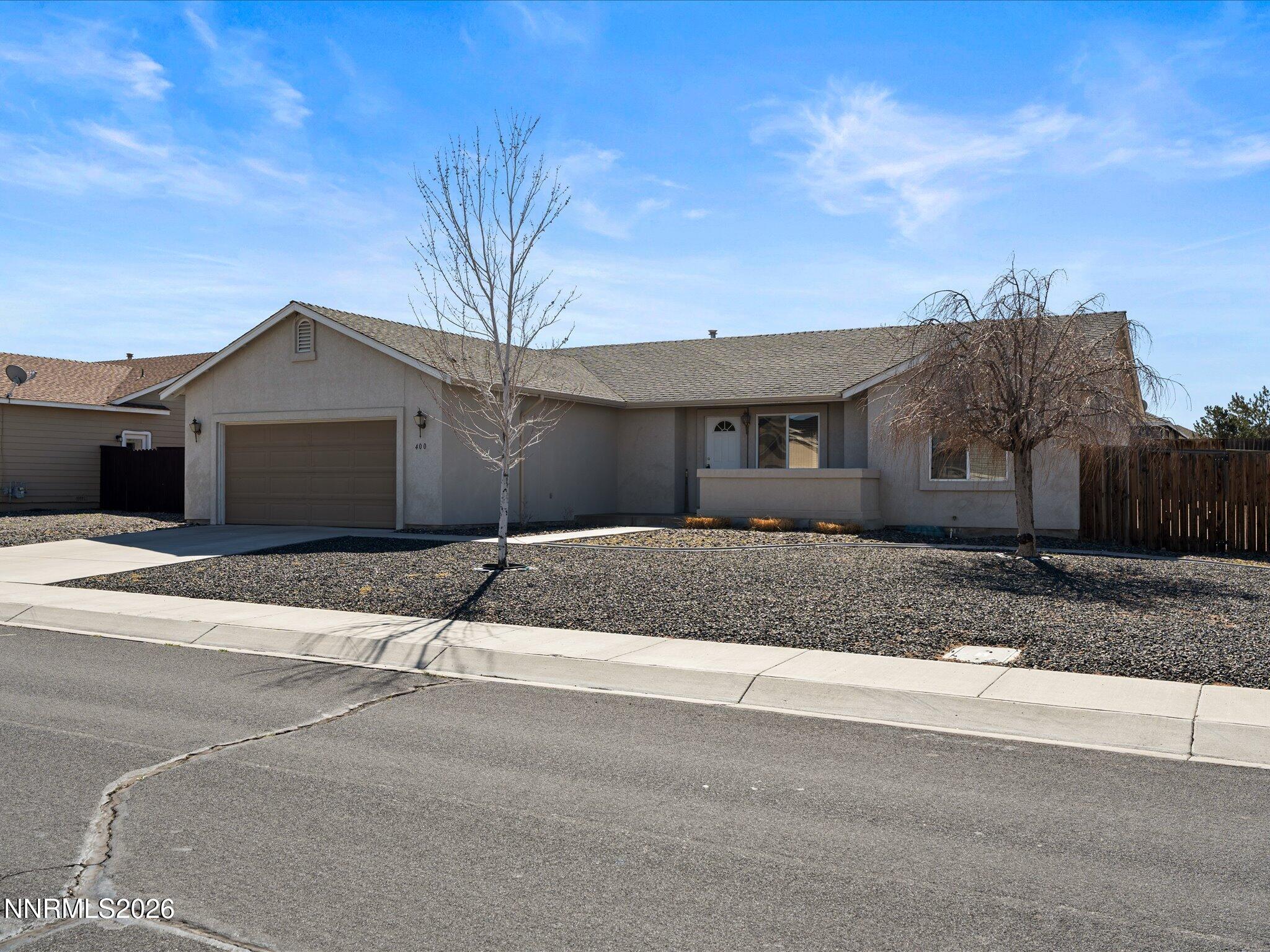 400 Bens Way Fernley, NV 89408 - Photo 3 of 31 a front view of a house with a yard and garage
