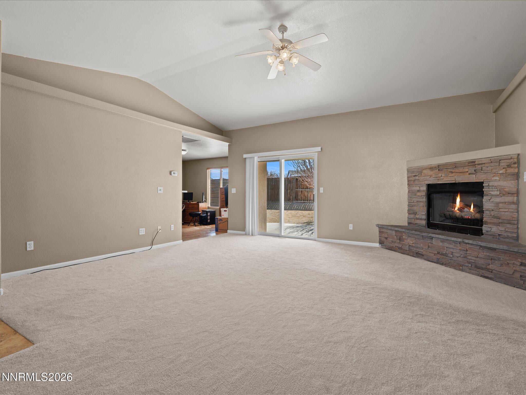 400 Bens Way Fernley, NV 89408 - Photo 6 of 31 a view of a livingroom with a fireplace a window and a fireplace