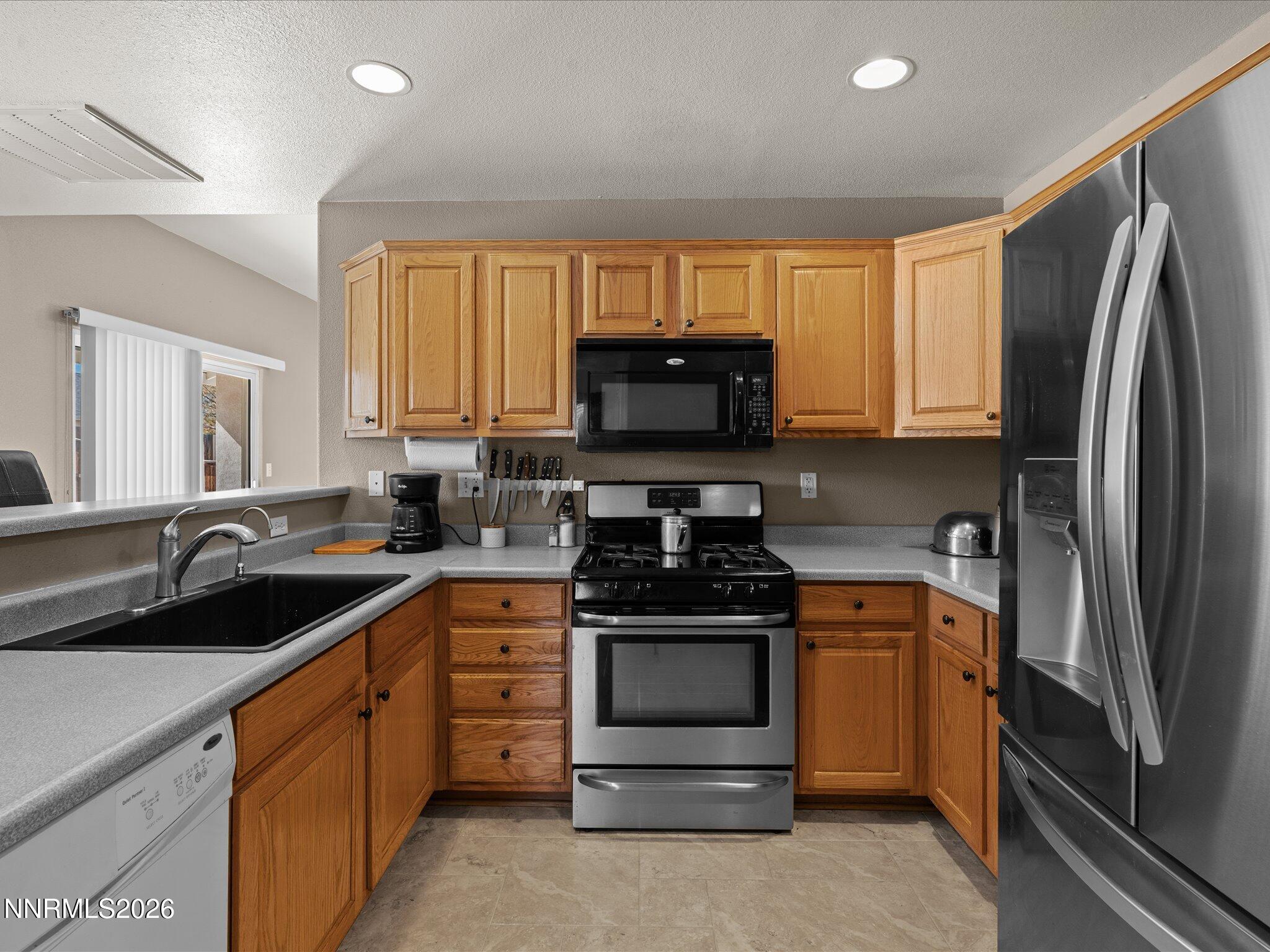 400 Bens Way Fernley, NV 89408 - Photo 8 of 31 a kitchen with a sink stove and refrigerator