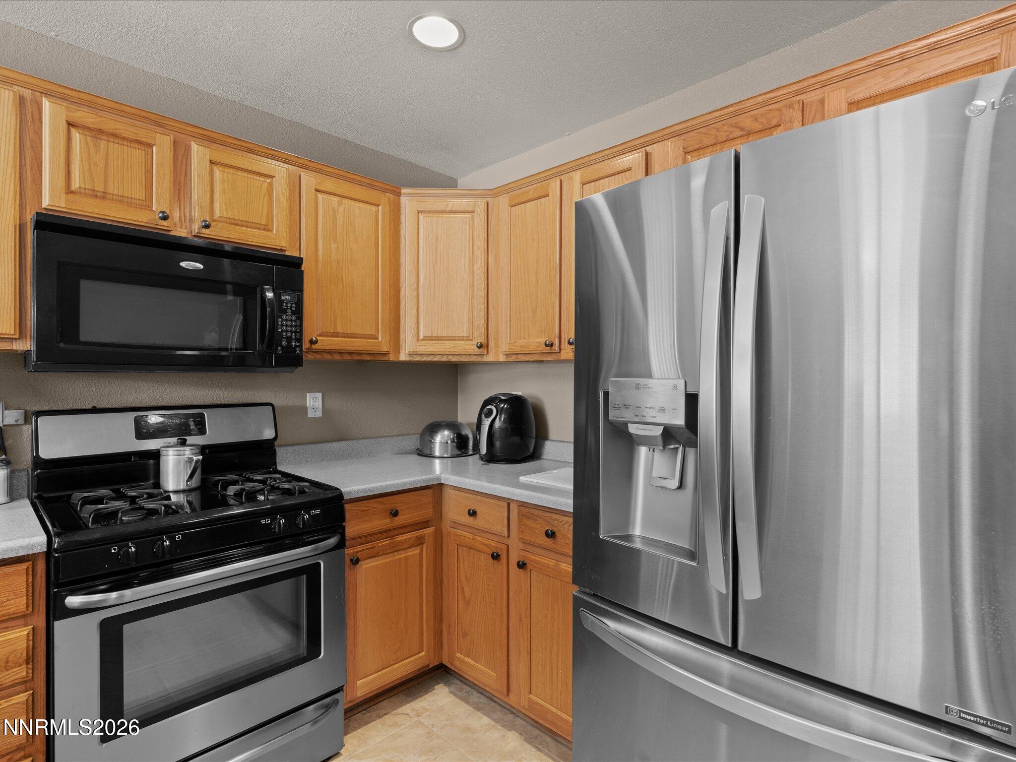 400 Bens Way Fernley, NV 89408 - Photo 9 of 31 a kitchen with stainless steel appliances granite countertop a refrigerator stove and microwave
