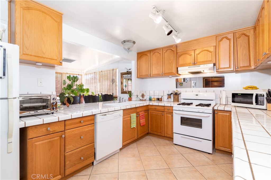 41320 Linda Vista Court Hemet, CA 92544 - Photo 11 of 31 a kitchen with stainless steel appliances granite countertop a sink and cabinets