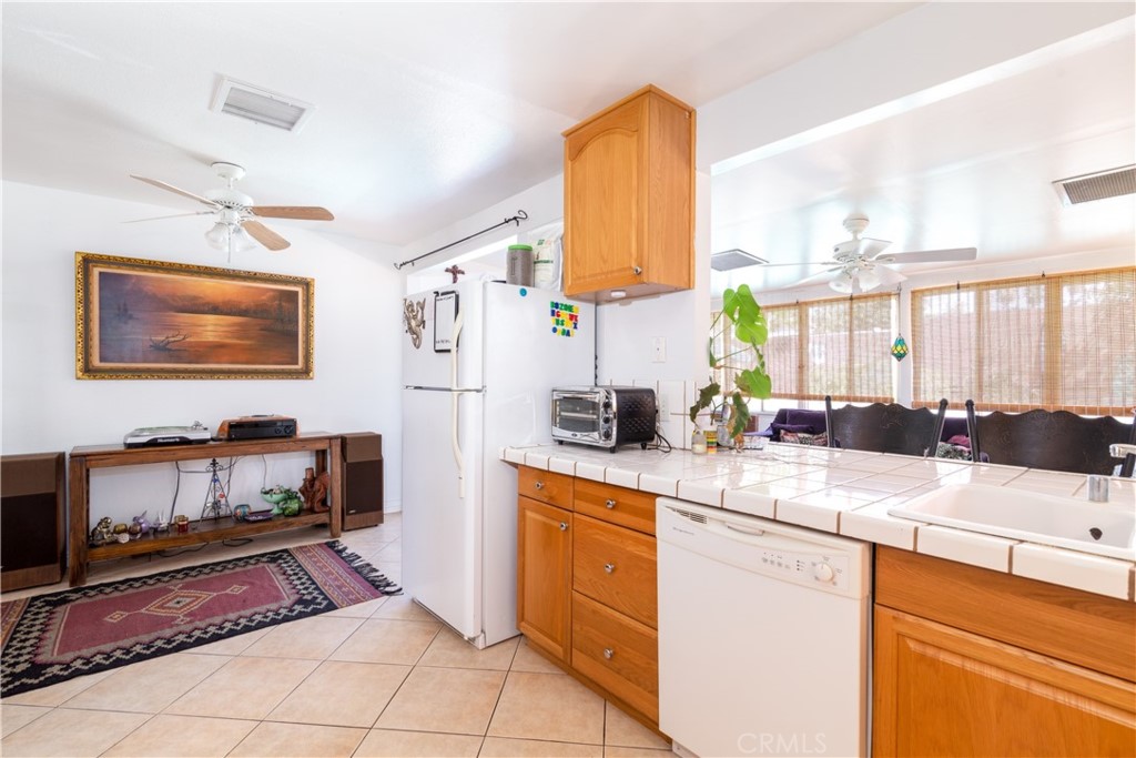 41320 Linda Vista Court Hemet, CA 92544 - Photo 12 of 31 a kitchen with a sink appliances and cabinets